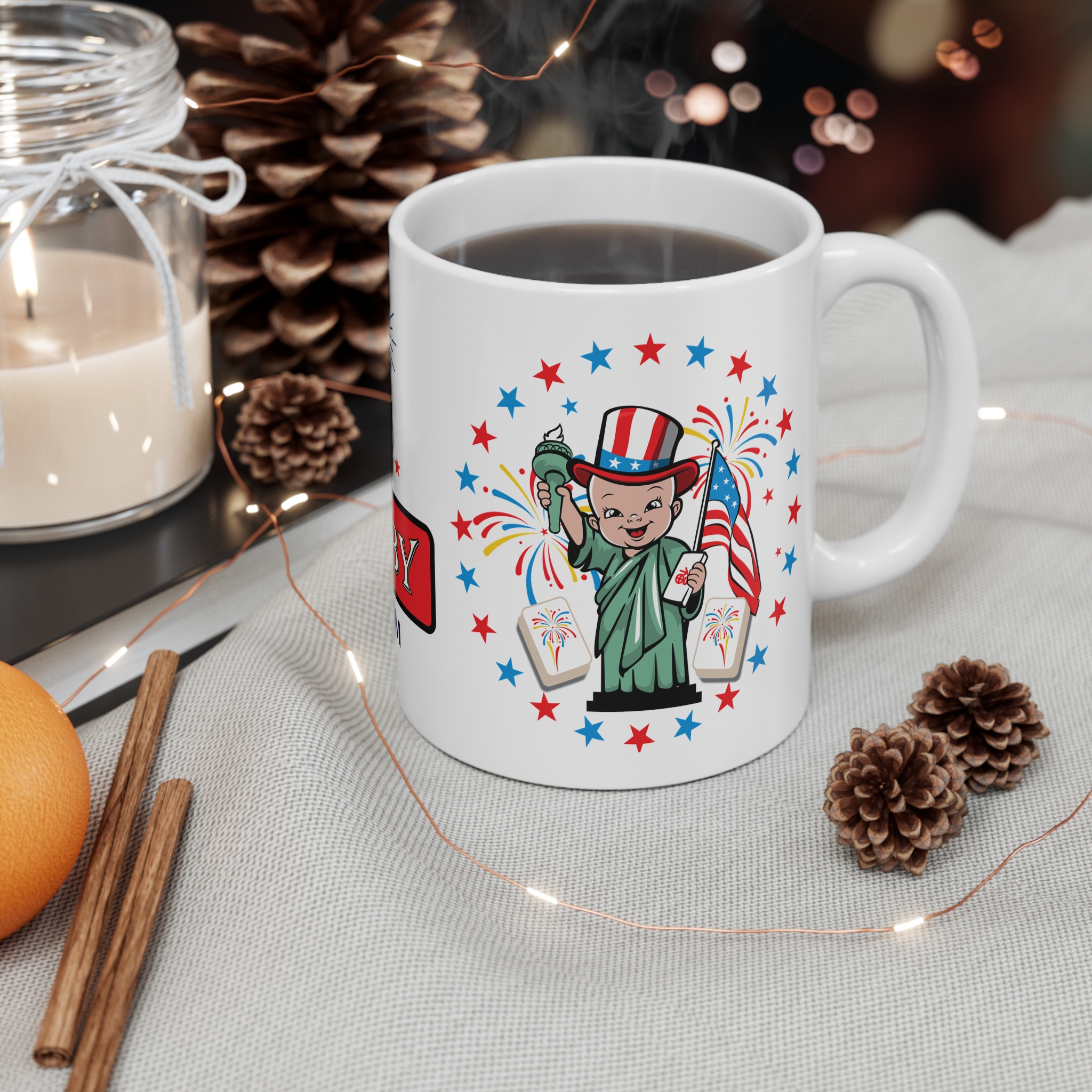 4th of July Mahjong Baby mug on table with candles and decor, patriotic 11oz coffee cup with Statue of Liberty mahjong design